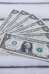 One dollars on wood background, money