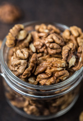 Walnuts. Walnut kernels and whole walnuts on rustic table.