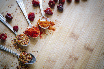 Various hot spices on a wooden background