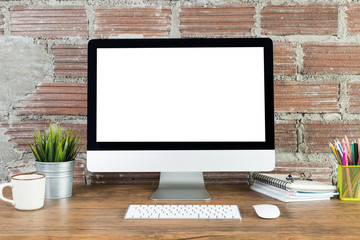Fototapeta premium workspace with computer with blank white screen, and office supplies on a wooden desk