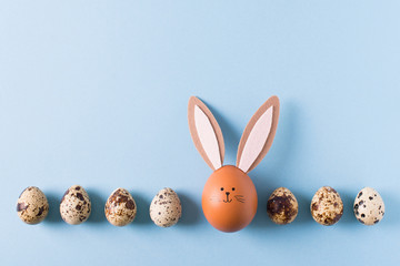 Frame from easter eggs with bunny on blue background