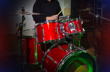 Fototapeta na wymiar Modern drum set on stage prepared for playing in bright blue light