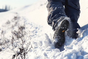 Person hiking on the mountaintop covered with snow low angle view