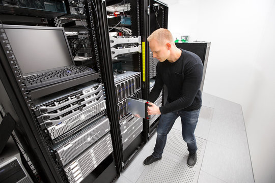 IT Technician Installing Blade Server In Chassis At Datacenter