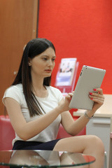Young beautiful business woman holding tablet