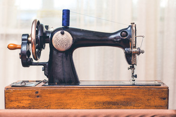 old antique sewing machine in robotic condition
