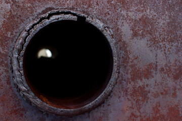 Background with a circular hole on a rusty metal surface