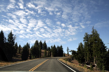 Fototapeta na wymiar Road in the Crater Lake National Park in a sunny day, Oregon, USA