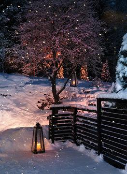 Fototapeta Lanterns in Christmas snowfall garden