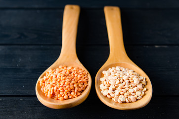 Spoons filled with uncooked lentil for soup