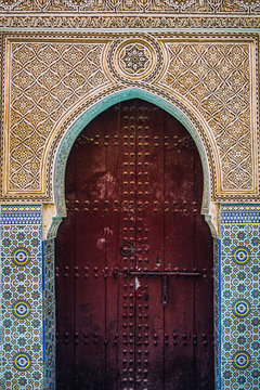 Moroccan door in a tile decorated building wall