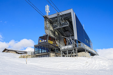 A ski piste and people ski in the snowscape of the alps in St Moritz Switzerland