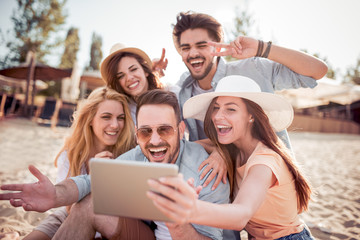 Obraz premium Group of friends taking a selfie with tablet ,having fun.