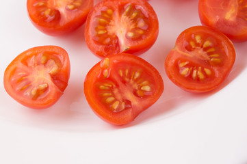 Sliced cherry tomatoes on a white plate