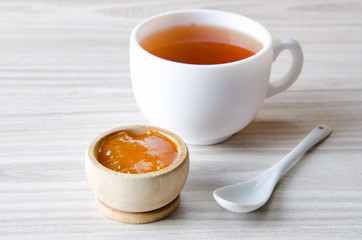 Cup of tea served with orange jam