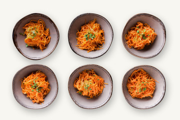 Set of plates with russian korean salad on white isolated background