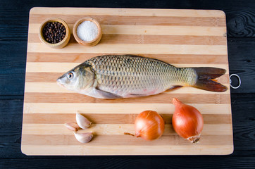 Uncooked fish on cutting board in meal preparation concept