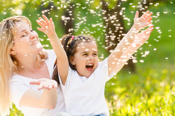 Mother and daughter in field with colorful flowers