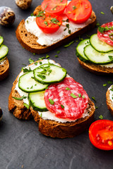 Homemade bruschetta. Mini sandwiches. Traditional spanish tapas on dark table. Brushetta set.