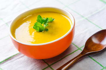 Carrot soup served on the table in bowl