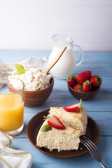 piece of strawberry cheesecake on plate with juice