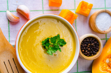 Pumpkin soup served on the table in bowl