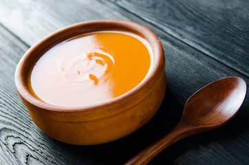 Carrot soup served on the table in bowl