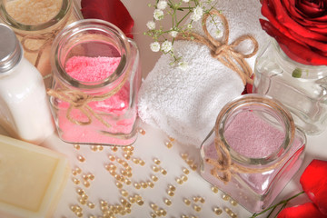 Obraz na płótnie Canvas rose bath salt gray soap and red rose petals with pearls of vitamins