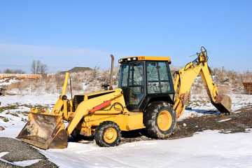 New Home Under Construction in Winter with Heavy Equipment, Machinery Vehicles