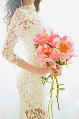 Beautiful young woman with pink peony