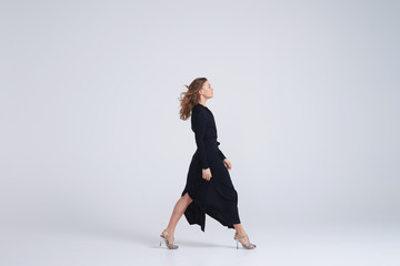 Woman model walking in trend black dress