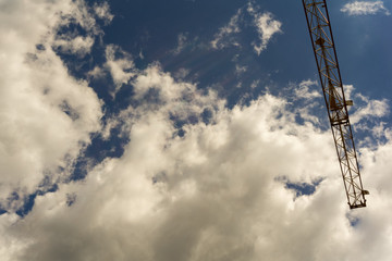 Part of a crane below a cloudy summer sky - Powered by Adobe