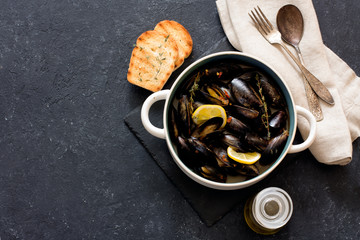 Mussels in copper pot  preparing with thyme and lemon