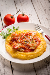 cod with tomato sauce and porridge, selective focus
