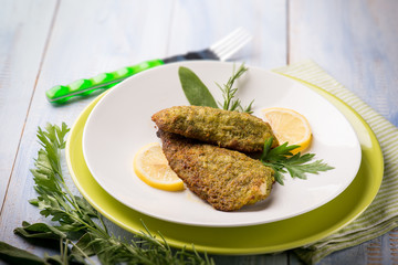 breaded fish with aromatic herbs, selective focus