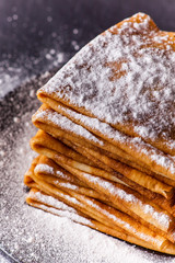 Stack of crepes with powdered sugar on dark background. Maslenitsa. Russian folk festival - 189071581