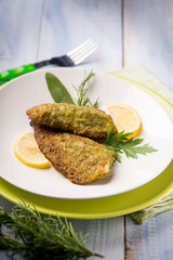 breaded fish with aromatic herbs, selective focus