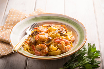 tagliatelle with shrimp and porcino mushroom, selective focus