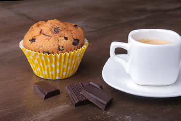 Homemade muffin with raisins and cup classic espresso coffee. selective focus.