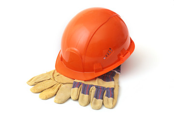 Orange hard hat, safety gloves on white background. Safety helmet.