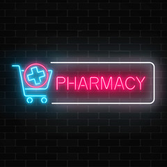 Obraz premium Neon pharmacy glowing signboard with medical cross in shopping cart on brick wall background.