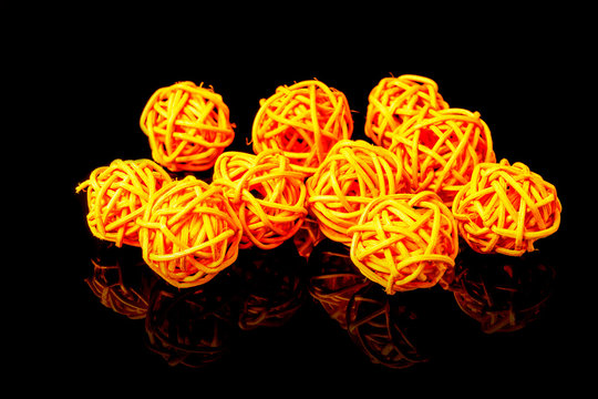 Orange rattan light balls on black background. Creative decoration concept for Christmas celebration and Holiday.