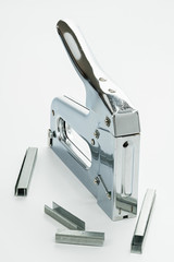 Chrome colored staple gun on white