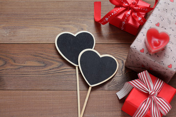 Gift boxes with hearts on a wooden table