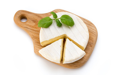 Piece of camembert cheese isolated on white background. From top view.