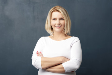 Confident mature woman posing in studio. Portrait shot