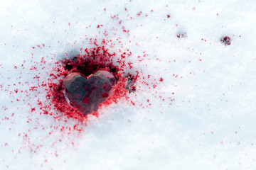 crystal heart lies on the snow in the blood, drops of blood on the snow, copy space, .close up,...