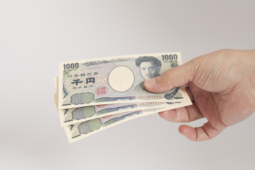 Japanese money one thousand yen in man hand