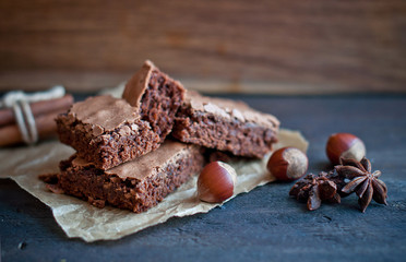 Brownie chocolate cake on dark  background, cooking sweet dessert. Close-up.