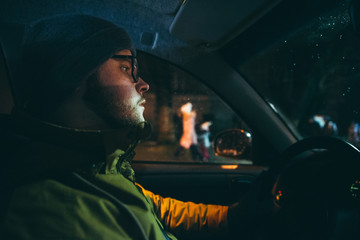 young man drive car in evening